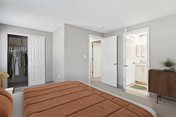 A bedroom with a bed and a closet with closets